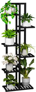 Black 6 tier bamboo plant stand holding potted plants on staggered shelves