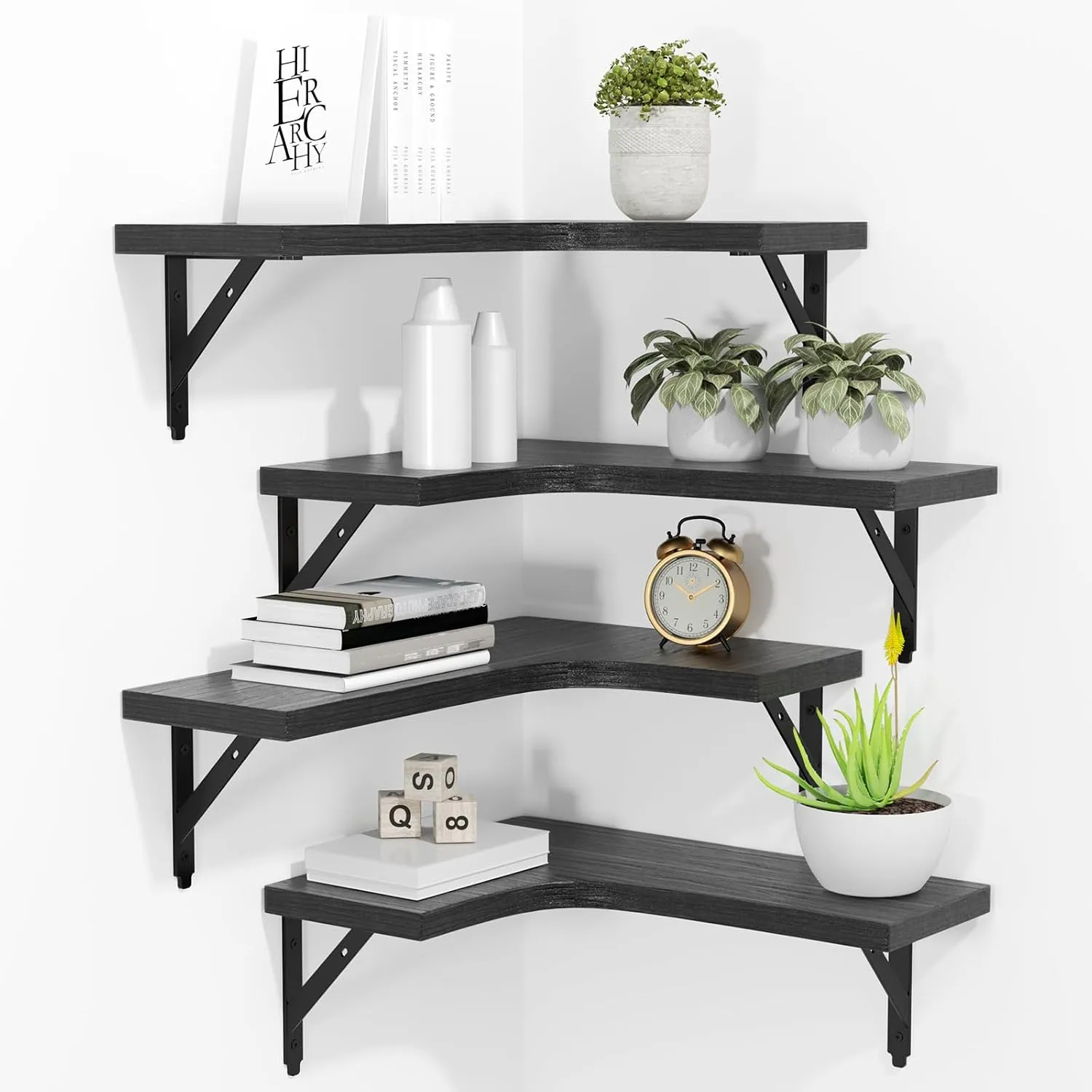 Four black corner shelves on black metal brackets, styled with plants, books, a clock and vases